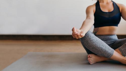 Fitness woman in a Padmasana pose - 1225430