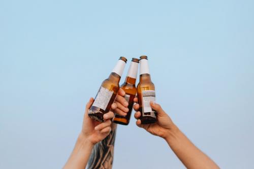 Guys having beers at the beach - 1228391