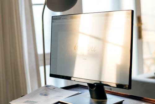 Computer monitor on wooden table - 388476