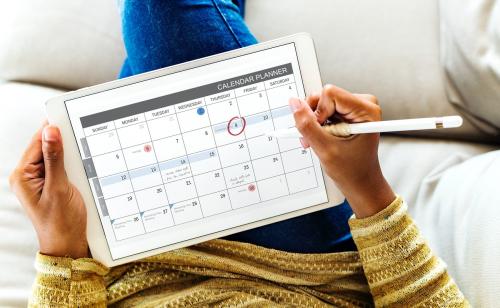 Woman checking calendar on digital tablet - 400357