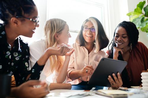 Fashion designers having a meeting using a digital tablet - 1211574