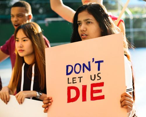 Group of teenagers protesting holding posters saying don't let us die antiwar justice peace concept - 401541