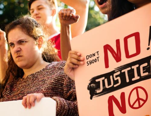 Closeup of angry teen girl protesting demonstration holding posters antiwar justice peace concept - 401546