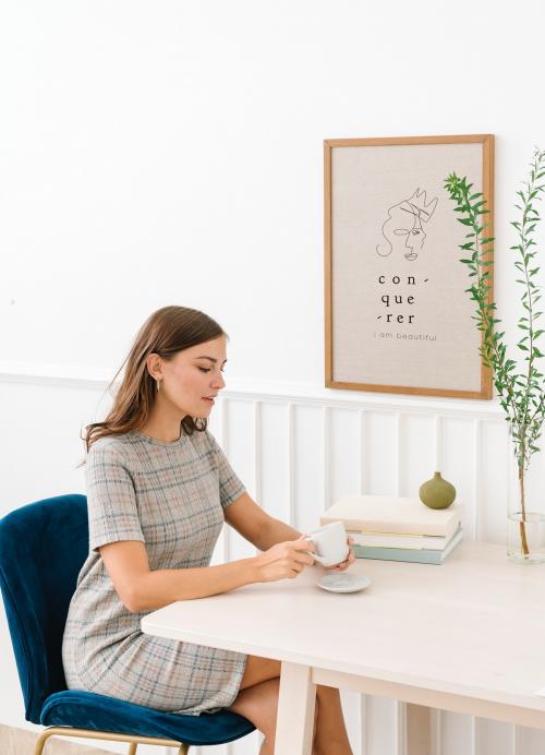 Woman sitting on a chair holding coffee cup - 1212611