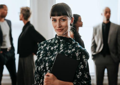 Confident businesswoman standing with a digital tablet - 1216664