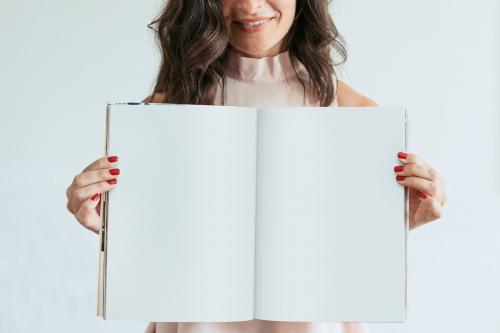 Happy woman holding an empty notebook - 1224214