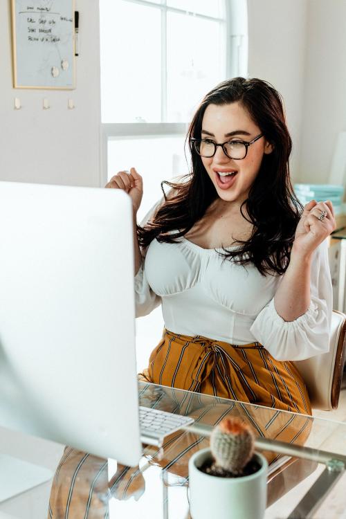 Happy woman working on her computer - 1225045