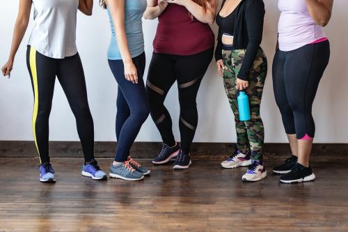 Sporty women standing against a white wall - 1225087