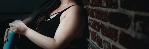 Tired woman against a brick wall banner - 1225152