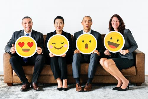 Cheerful people holding emoticon icon - 414487