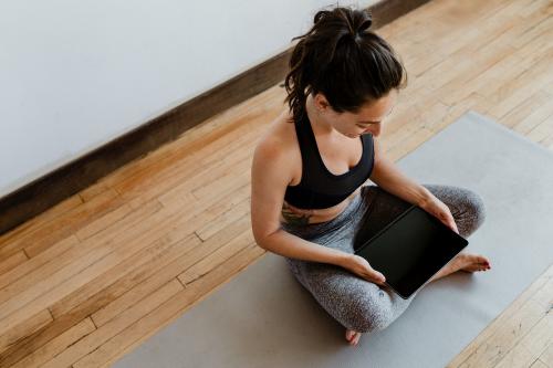 Yoga instructor using a digital tablet mobile phone wallpaper - 1225637