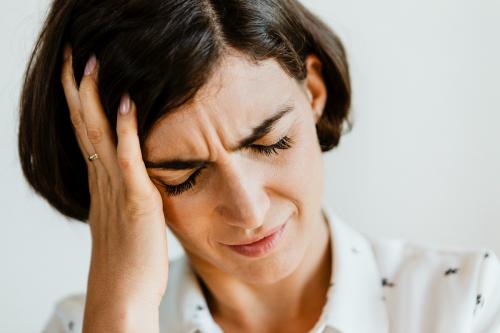 Unhappy woman holding her forehead - 1226556