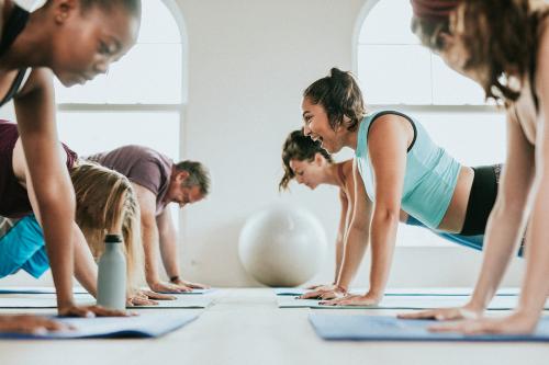 Group of people doing full plank pose - 1226918