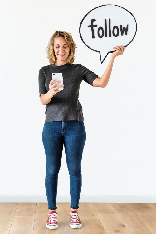 Woman using smartphone and holding follow icon - 414537