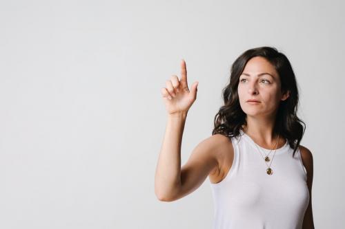 Woman touching a screen with her finger - 1233758