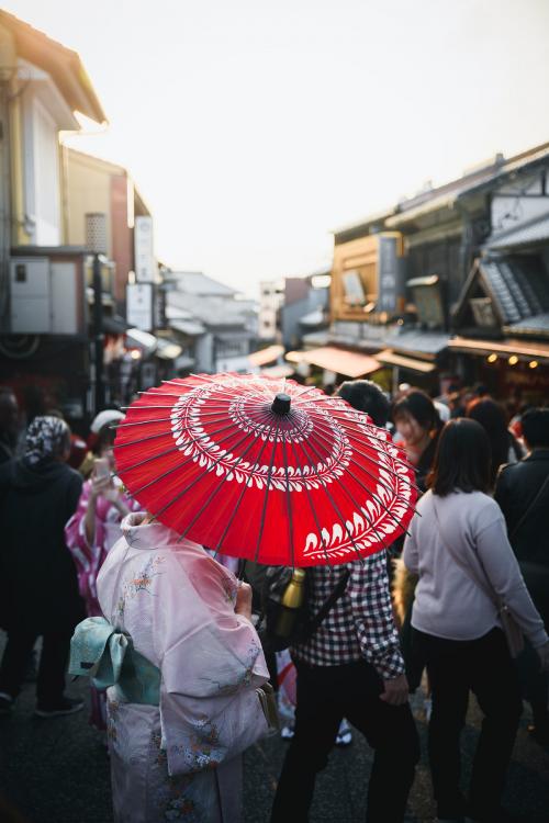 Woman in yukata walking on a crowded street - 843903