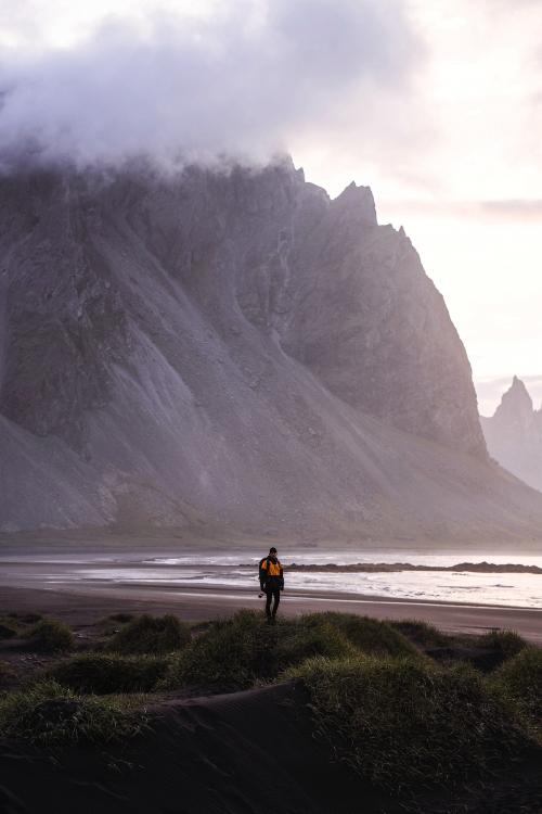 Photographer on a green hill at the Stokksnes peninsula in Southeast Iceland - 1205991