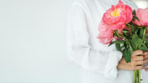 Woman holding a bouquet of peonies - 1207569