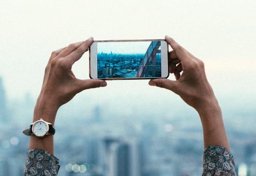 Woman taking a photo of the sunset - 326890