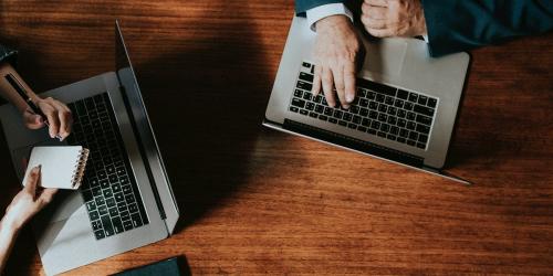 Business people in a meeting using their laptops - 1210044