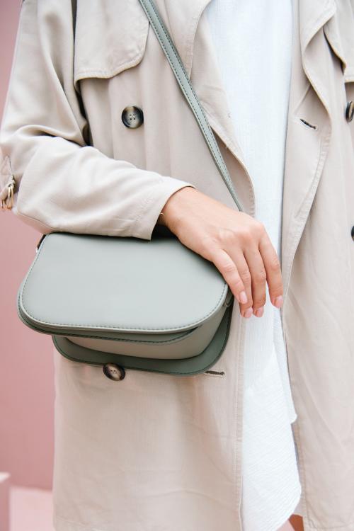 Woman in a beige coat with her shoulder bag - 1212513