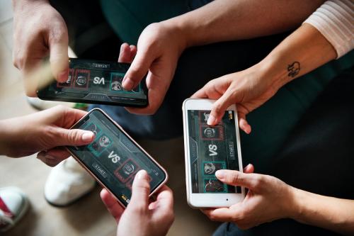 Group of diverse friends playing game on mobile phone - 384544