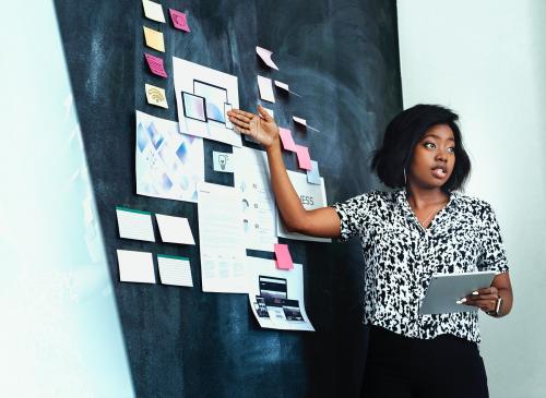 Businesswoman brainstorming using a blackboard - 1213747