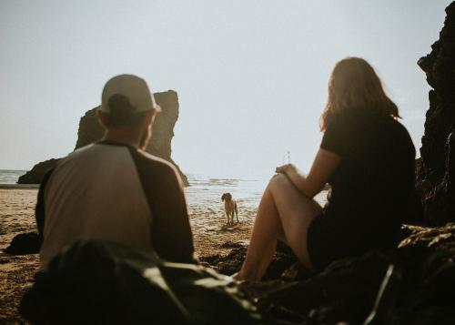 Friends enjoying at the beach with a dog - 1215610