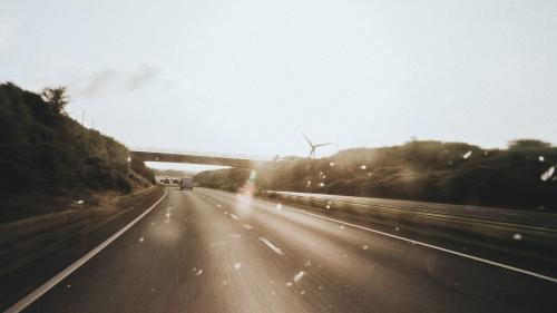 Passing windmills on a road trip - 1215643