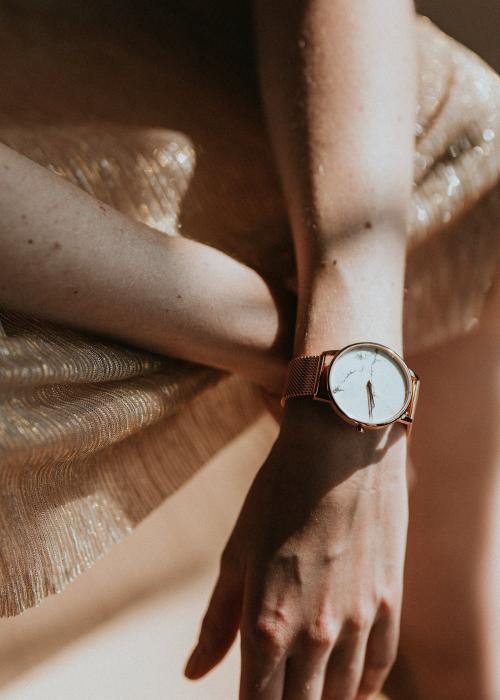 Woman wearing a pink gold wristwatch - 1216493