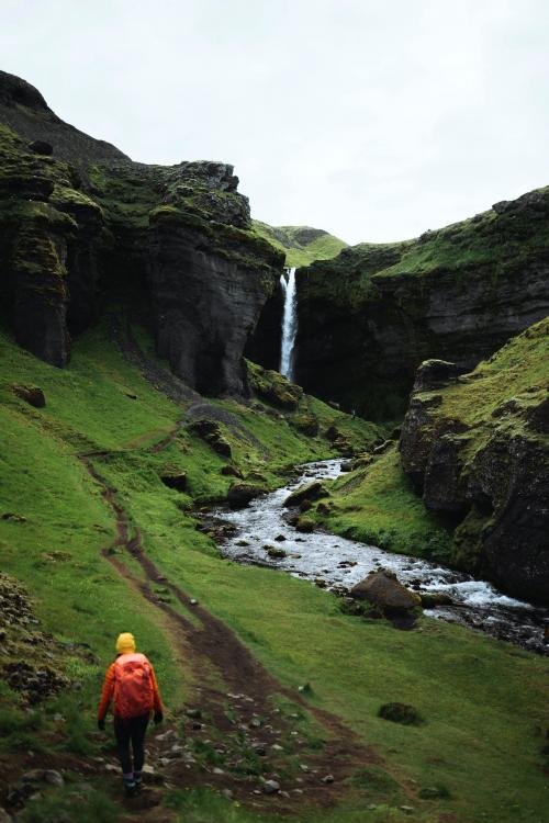 Female hiker with a view of Kvernufoss waterfall in South Iceland - 1206174