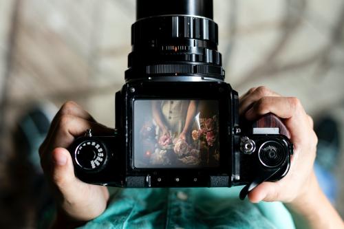 Florist arranging flowers on a professional camera - 1207060