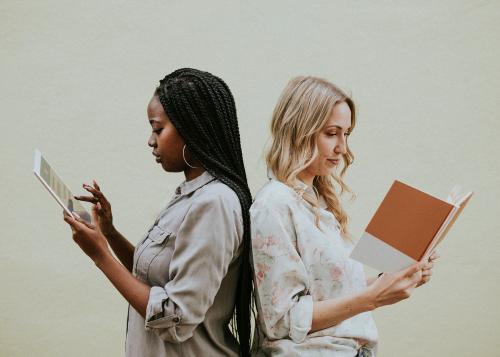 Diverse women reading a book and using a tablet - 1208394