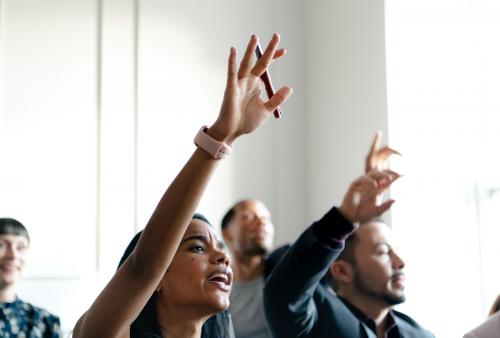 Business people in a seminar raising their hands - 1208676