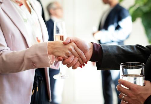 Business people shaking hands at an office party - 1208698