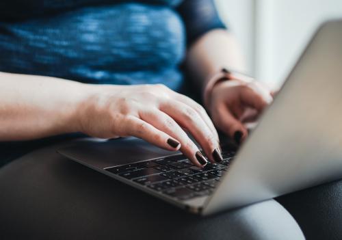 Woman typing on her laptop - 1209068