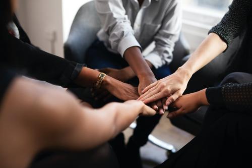 Fashion designers doing a hand stack at a meeting - 1211532