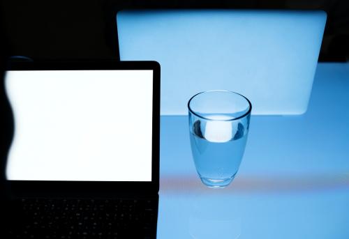 Office desk with a laptop and a glass of water - 311640