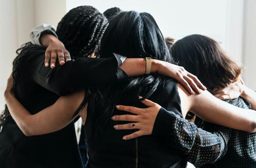 Happy diverse businesswomen huddling in the office - 1211561