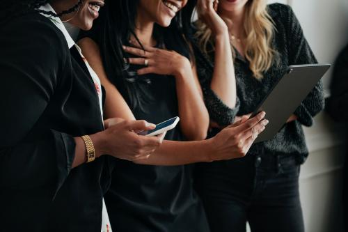 Happy businesswomen using digital devices - 1211572