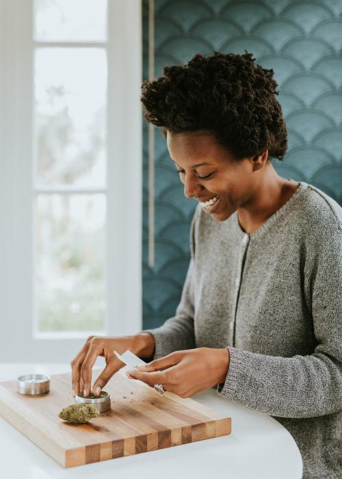 African woman rolling a weed joint - 1211759