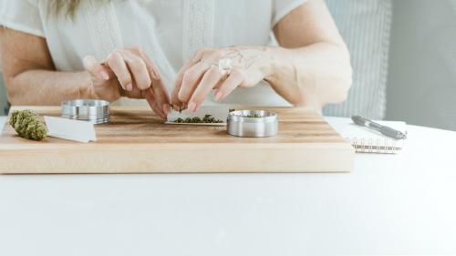 Rolling a weed joint at a chopping block - 1211881