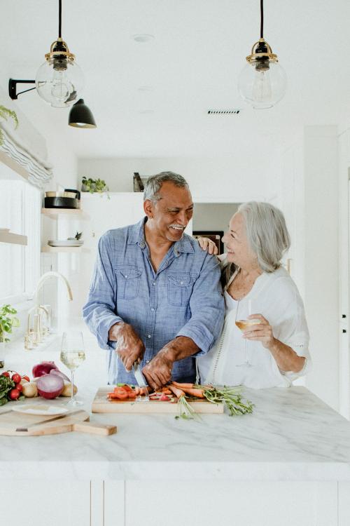 Elderly couple cooking in a kitchen - 1211884