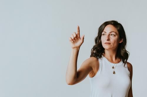 Woman pressing her finger to a screen - 1213905