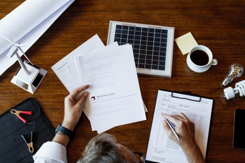 Eco-friendly engineer working on a solar panel project - 1213920