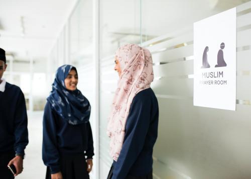 A group of Muslim students and the prayer room sign - 260566