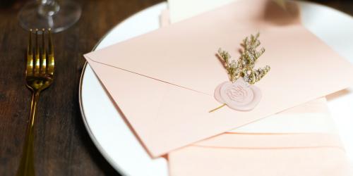 Floral stamped pink envelope on a plate - 1207167