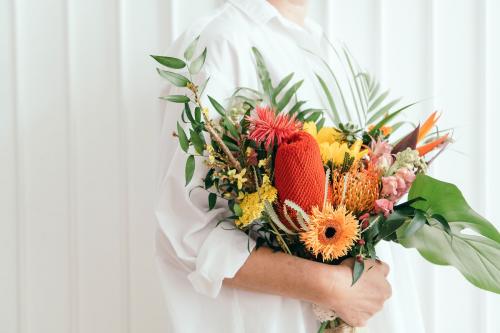 Woman holding a colorful tropical bouquet - 1207347