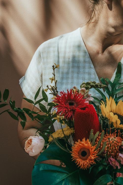 Woman with a beautiful tropical bouquet - 1207443