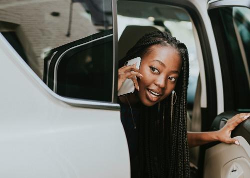 Happy woman on the phone in a car - 1208307